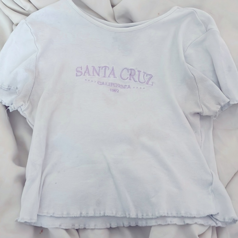 white/purple crop top, purple letters “Santa Cruz California 1992”